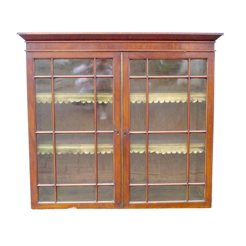 248 - An early Victorian mahogany bookcase, top section only, the twin doors with glazed panels, enclosing... 