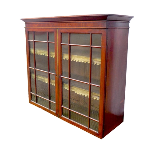 248 - An early Victorian mahogany bookcase, top section only, the twin doors with glazed panels, enclosing... 