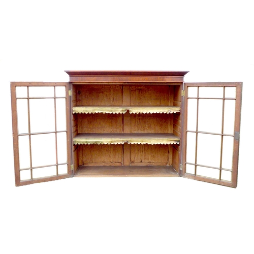 248 - An early Victorian mahogany bookcase, top section only, the twin doors with glazed panels, enclosing... 