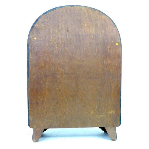 256 - A 1930s oak veneered bookcase,  with domed top and twin glazed doors, enclosing three adjustable she... 