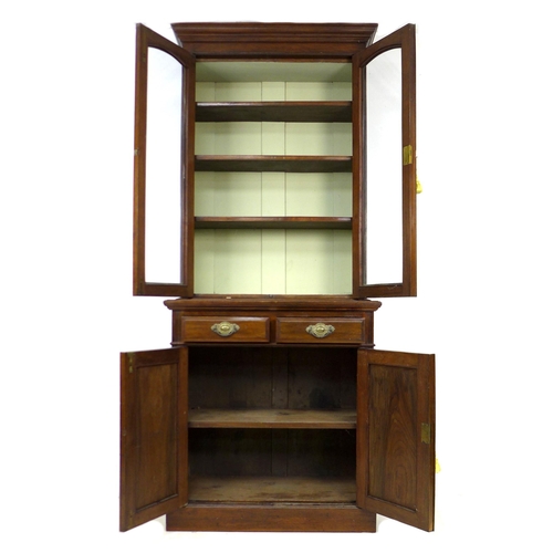 257 - An Edwardian mahogany bookcase, with three shelves behind two glazed doors, upon two drawers and a c... 