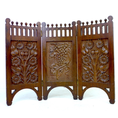 261 - An Edwardian three panel carved mahogany screen, decorated with panels of flowers, grapes and sunflo... 