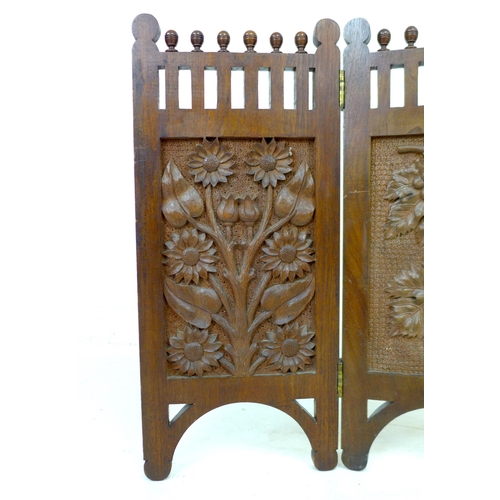 261 - An Edwardian three panel carved mahogany screen, decorated with panels of flowers, grapes and sunflo... 