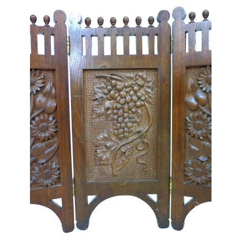 261 - An Edwardian three panel carved mahogany screen, decorated with panels of flowers, grapes and sunflo... 