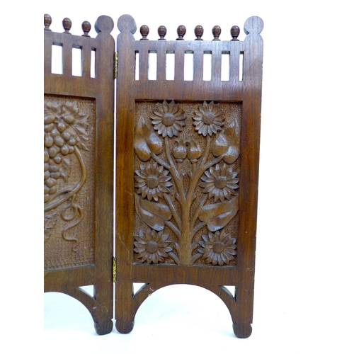 261 - An Edwardian three panel carved mahogany screen, decorated with panels of flowers, grapes and sunflo... 