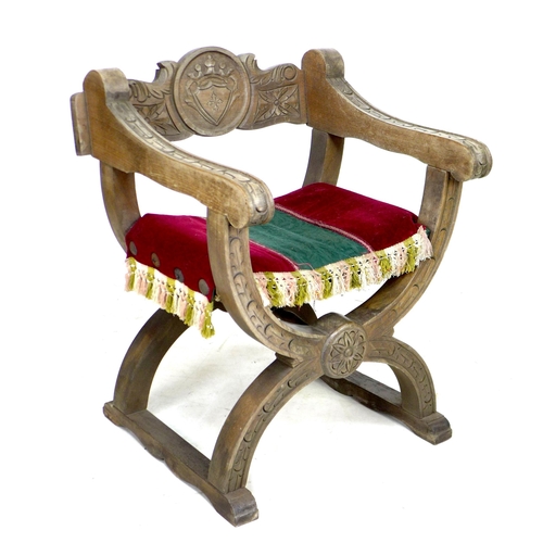 268 - A carved work curule open armchair with upholstered seat, 62 by 54 by 75cm high.