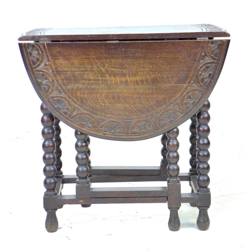 272 - A Victorian oak drop leaf table, the oval surface with carved lunette border to the edge, gate leg a... 