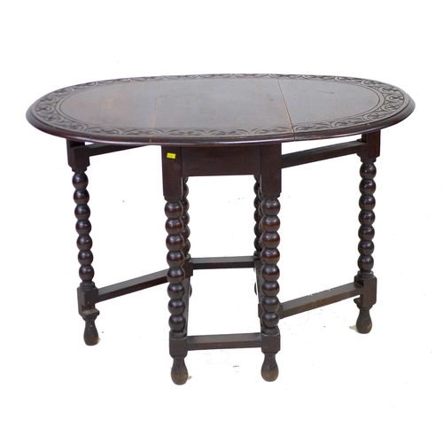 272 - A Victorian oak drop leaf table, the oval surface with carved lunette border to the edge, gate leg a... 