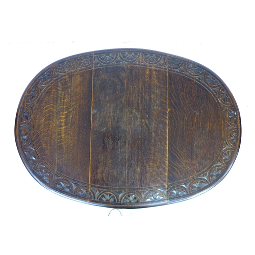 272 - A Victorian oak drop leaf table, the oval surface with carved lunette border to the edge, gate leg a... 