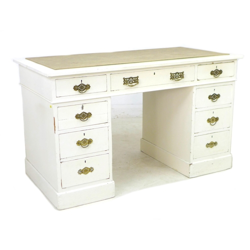 281 - A late Victorian mahogany pedestal desk, painted white, with nine drawers, brass handles, and cream ... 