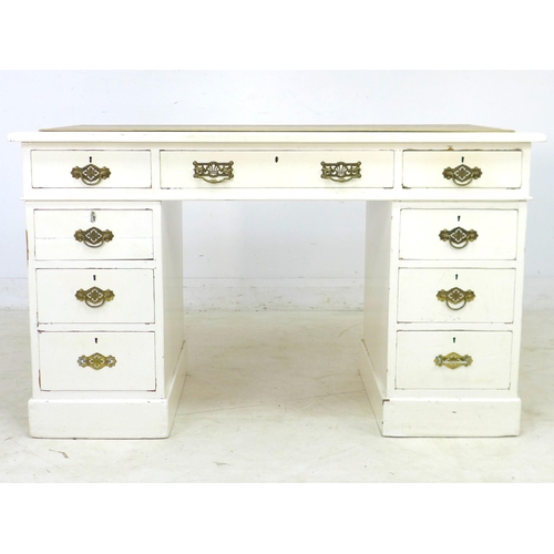 281 - A late Victorian mahogany pedestal desk, painted white, with nine drawers, brass handles, and cream ... 