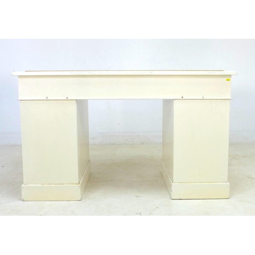 281 - A late Victorian mahogany pedestal desk, painted white, with nine drawers, brass handles, and cream ... 