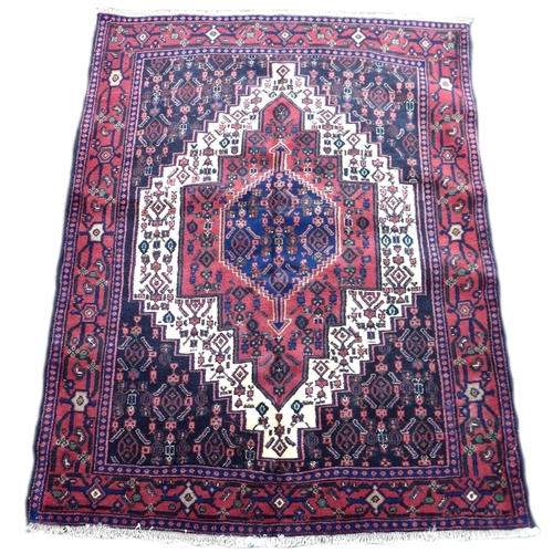 282 - A Senneh rug on red ground, with central hexagonal medallion with pendant anchors, surrounded by a c... 