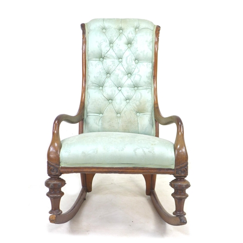 286 - A Victorian mahogany rocking chair, upholstered in button back fabric, with carved decoration to the... 