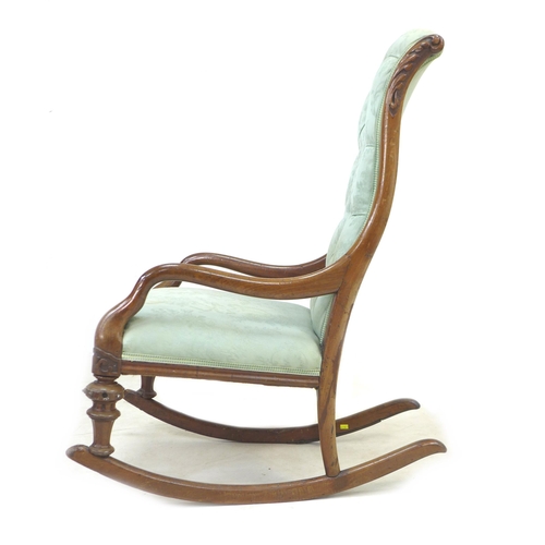 286 - A Victorian mahogany rocking chair, upholstered in button back fabric, with carved decoration to the... 