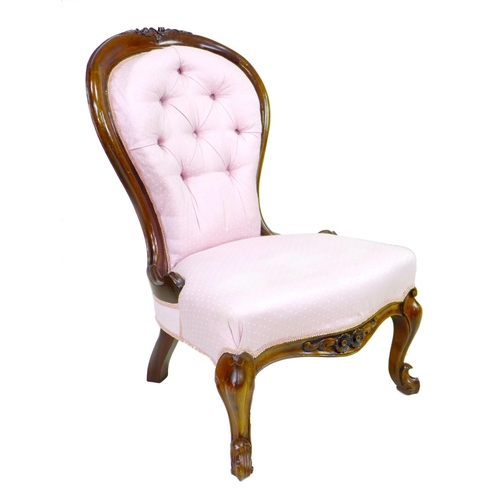 289 - A Victorian mahogany nursing chair, carved frame, upholstered in pink fabric, raised on cabriole fro... 