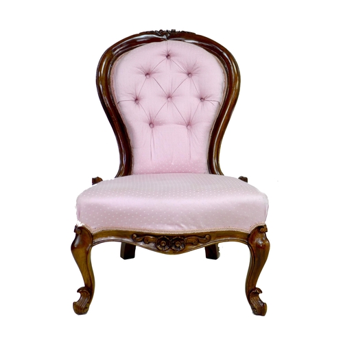 289 - A Victorian mahogany nursing chair, carved frame, upholstered in pink fabric, raised on cabriole fro... 