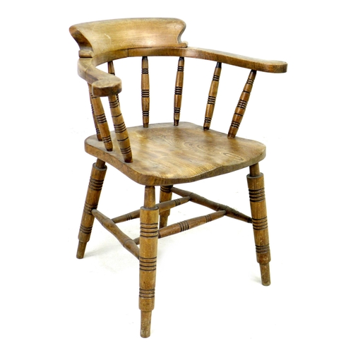 293 - A 19th century oak smokers bow armchair, with stamped maker's mark 'Elliot & Sons JJH', raised on tu... 