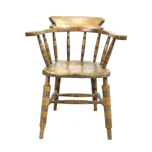 293 - A 19th century oak smokers bow armchair, with stamped maker's mark 'Elliot & Sons JJH', raised on tu... 