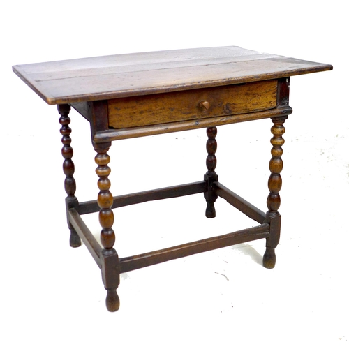 297 - A 17th century oak side table, the rectangular three plank surface with breadboard ends, above a sin... 