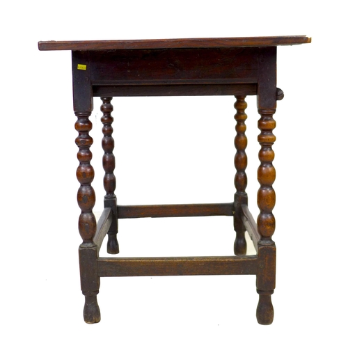 297 - A 17th century oak side table, the rectangular three plank surface with breadboard ends, above a sin... 