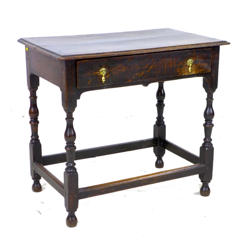 299 - A 17th century oak side table, the rectangular surface above a single frieze drawer with brass drop ... 