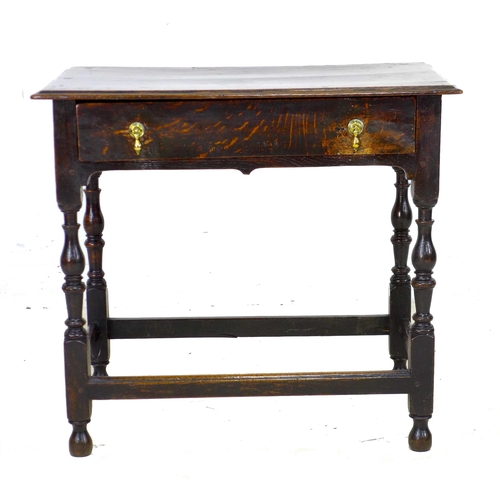 299 - A 17th century oak side table, the rectangular surface above a single frieze drawer with brass drop ... 