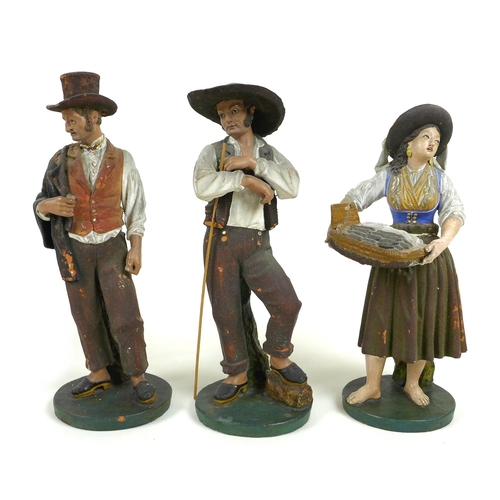 30 - A group of three early to mid 20th century Portuguese terracotta figures, modelled as a fisher-women... 
