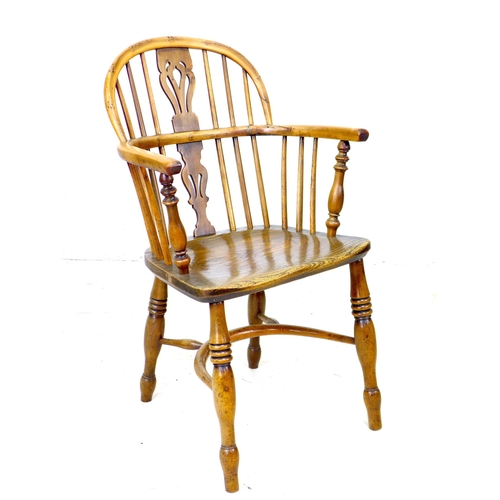 300 - A Georgian oak and yew Windsor armchair, low rounded back with pierced splat and stick supports, sha... 