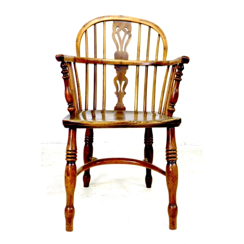 300 - A Georgian oak and yew Windsor armchair, low rounded back with pierced splat and stick supports, sha... 