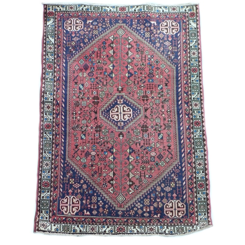 301 - An Abadeh rug with dark blue ground, with large pink central hexagonal panel containing a blue and c... 