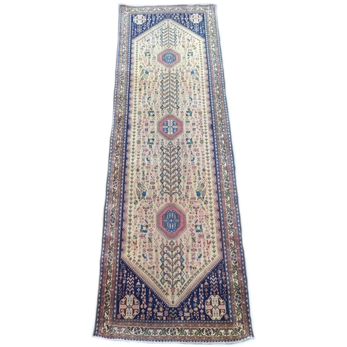 305 - An Abadeh runner on dark blue ground with large cream central medallion, containing three small salm... 