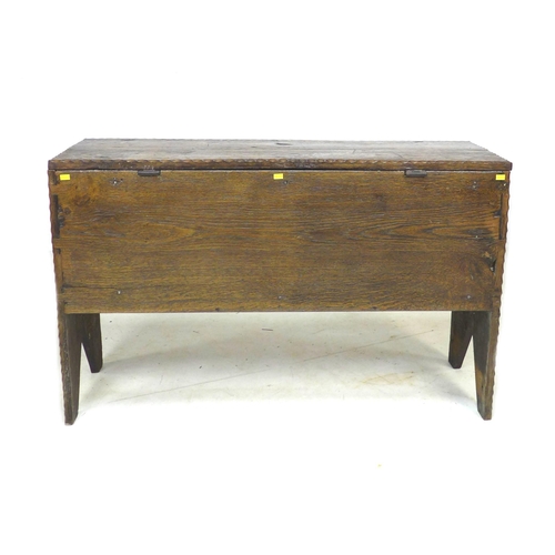 307 - A 17th century oak coffer, with lift lid and sides descending to V cut-out supports, 102 by 34 by 64... 