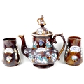 A Victorian bargeware teapot, applied plaque inscribed 'A Present From A Friend', 36cm high, togethe... 
