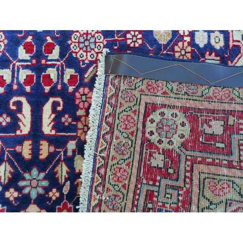 314 - A Sarouk rug on dark blue ground, with a cream central  medallion with pendant anchors, cream corner... 