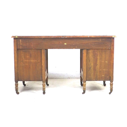 317 - A Continental fruitwood writing desk, with green leatherette surface, seven drawers with brass plate... 