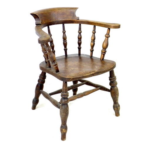 318 - A 19th century oak smokers bow armchair, with stamped maker's mark 'Johnson Holland & Co, Wycombe, 1... 