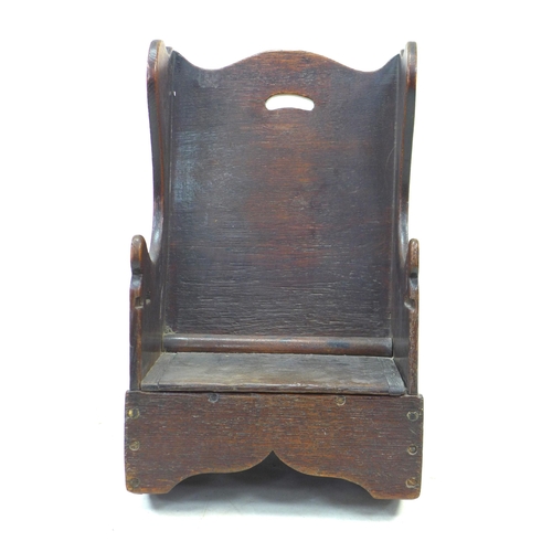 319 - An early 18th century oak child’s potty chair, with wing back and lift seat, 37.5 by 42 by 60cm high... 