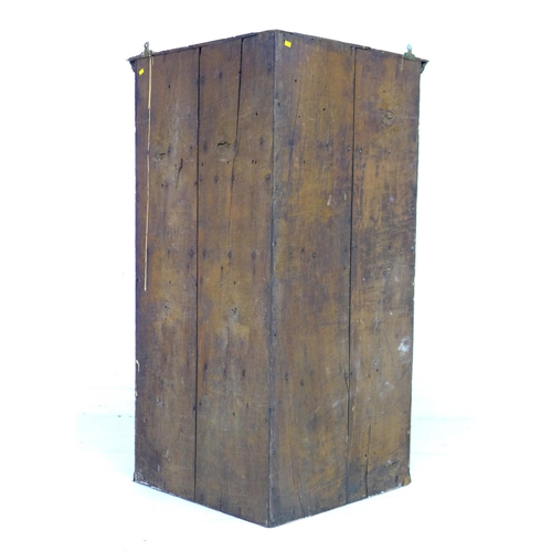 322 - A George III oak corner cupboard, with a single flat front fielded panel door, fixed shelves to inte... 