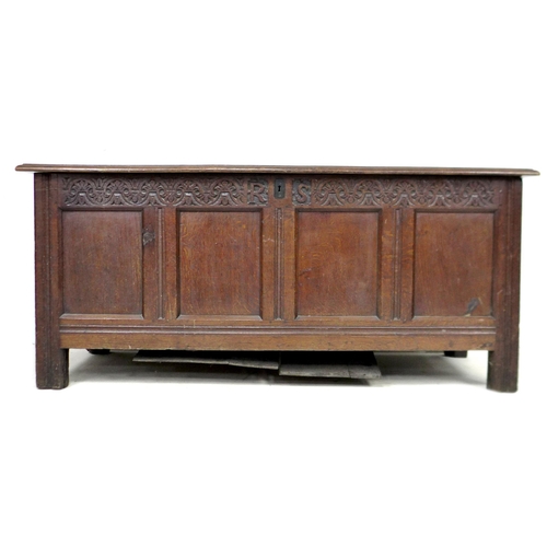 325 - An early 18th century oak coffer, with blind carved front, panelled sides, raised upon square sectio... 