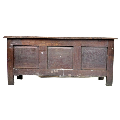 325 - An early 18th century oak coffer, with blind carved front, panelled sides, raised upon square sectio... 