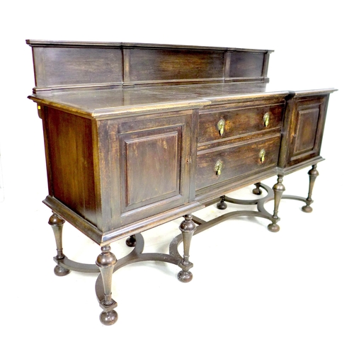 329 - An Edwardian oak sideboard, two central drawers flanked by two cupboards, brass drop handles, upstan... 