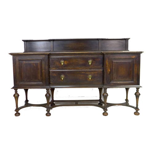 329 - An Edwardian oak sideboard, two central drawers flanked by two cupboards, brass drop handles, upstan... 