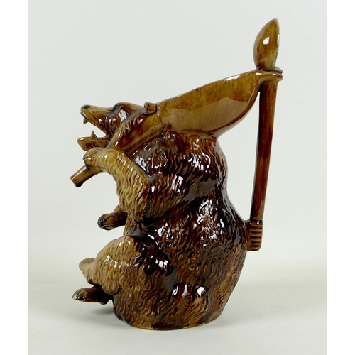 33 - A late 19th century German pottery novelty pitcher jug, modelled as a seated bear, mouth open from w... 