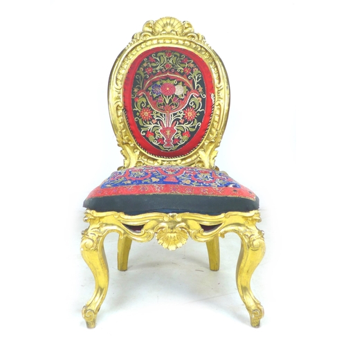 337 - A French early 19th century giltwood chair, with medallion back, shell and foliate decoration, uphol... 