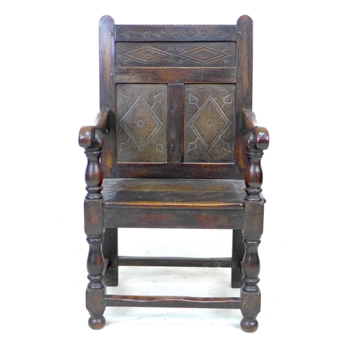 340 - A 17th century and later oak Wainscot armchair, the solid three panel back carved with geometric pat... 