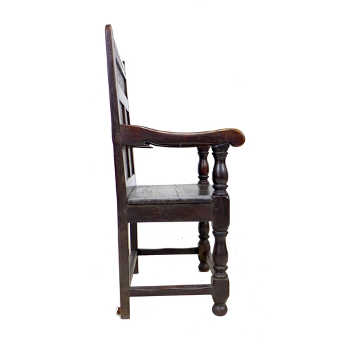 340 - A 17th century and later oak Wainscot armchair, the solid three panel back carved with geometric pat... 