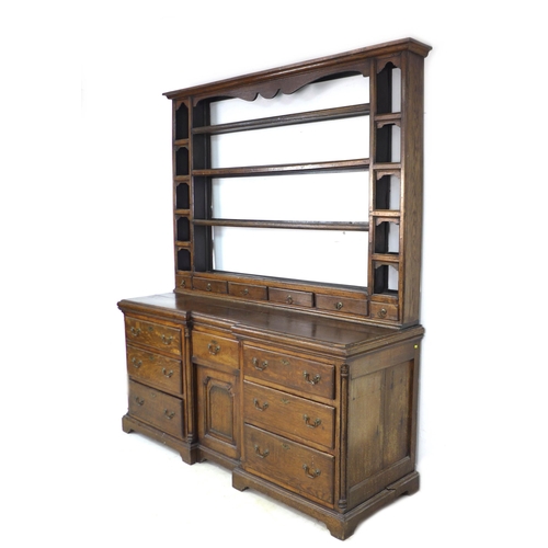 342 - A George II oak dresser, the rack with three shelves above six short drawers flanked by compartments... 