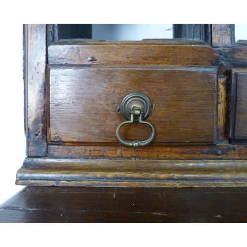 342 - A George II oak dresser, the rack with three shelves above six short drawers flanked by compartments... 