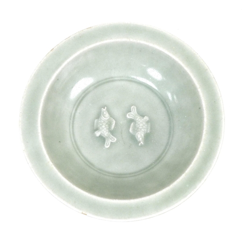 4 - A Chinese porcelain celadon dish, with lobed sides, with two underglaze relief carps to its centre, ... 